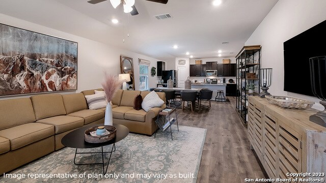 living room featuring hardwood / wood-style flooring and ceiling fan