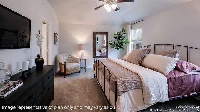 carpeted bedroom featuring ceiling fan and vaulted ceiling