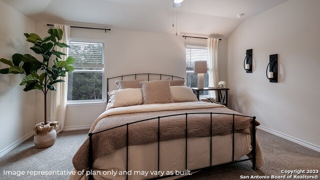 bedroom featuring carpet floors and vaulted ceiling