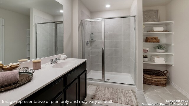 bathroom with tile patterned flooring, vanity, and a shower with shower door