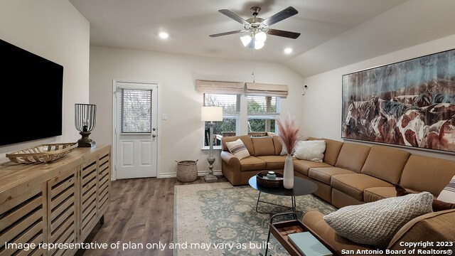 living room with ceiling fan, vaulted ceiling, and hardwood / wood-style flooring