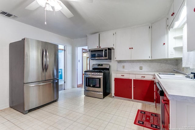 kitchen with sink, ceiling fan, tasteful backsplash, white cabinetry, and stainless steel appliances