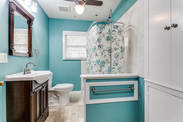 bathroom featuring vanity, toilet, and ceiling fan