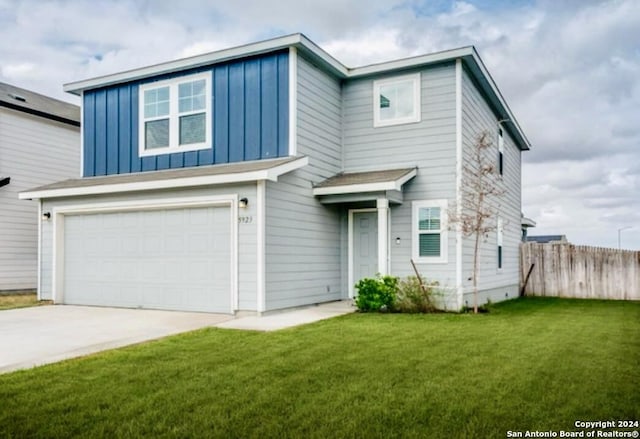 view of front facade featuring a front yard and a garage