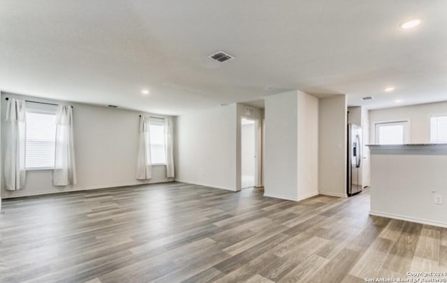 empty room with light hardwood / wood-style flooring