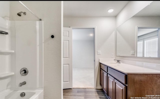 bathroom featuring shower / bathing tub combination, vanity, and hardwood / wood-style flooring