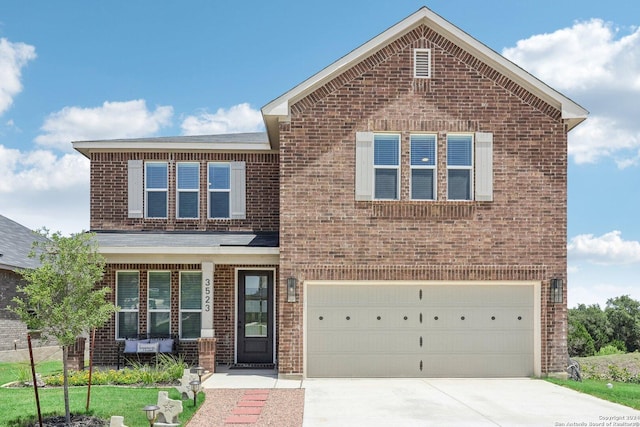 view of property with a front yard and a garage