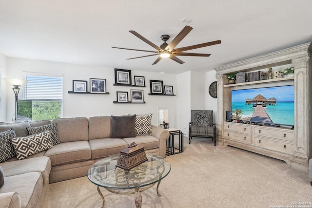 carpeted living room with ceiling fan