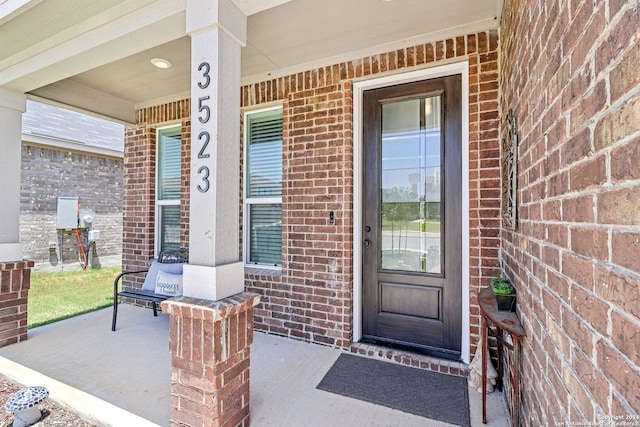 entrance to property featuring covered porch