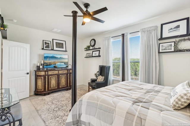 tiled bedroom featuring ceiling fan