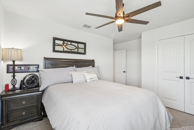 carpeted bedroom with a closet and ceiling fan