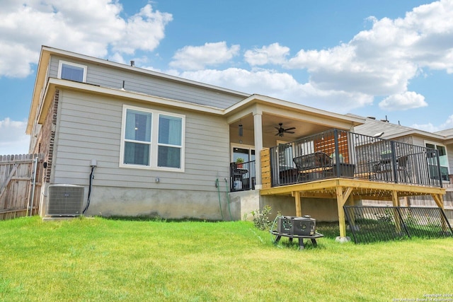 back of property with central AC, ceiling fan, a wooden deck, and a lawn