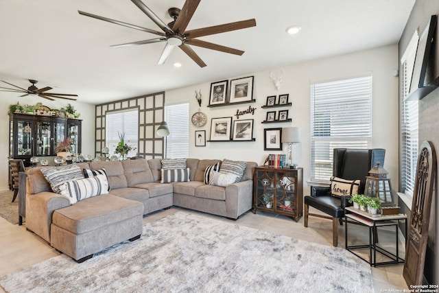 living room featuring light tile patterned floors, ceiling fan, and a healthy amount of sunlight