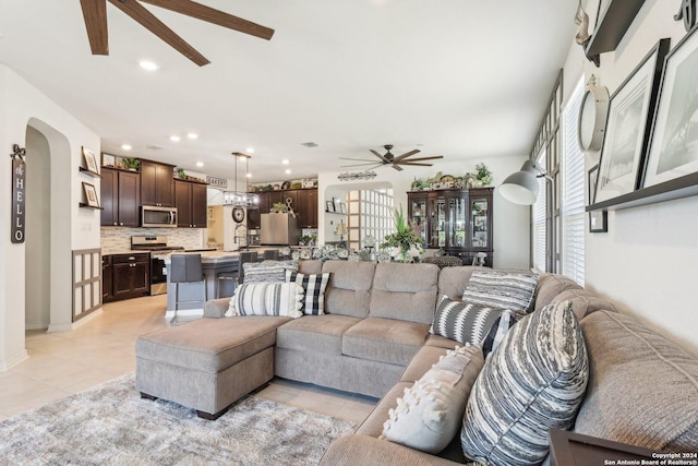 living room with ceiling fan and light tile patterned flooring