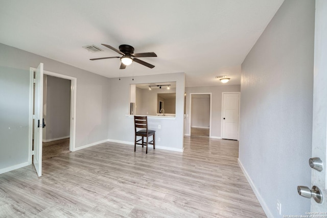 unfurnished living room with ceiling fan and light hardwood / wood-style flooring