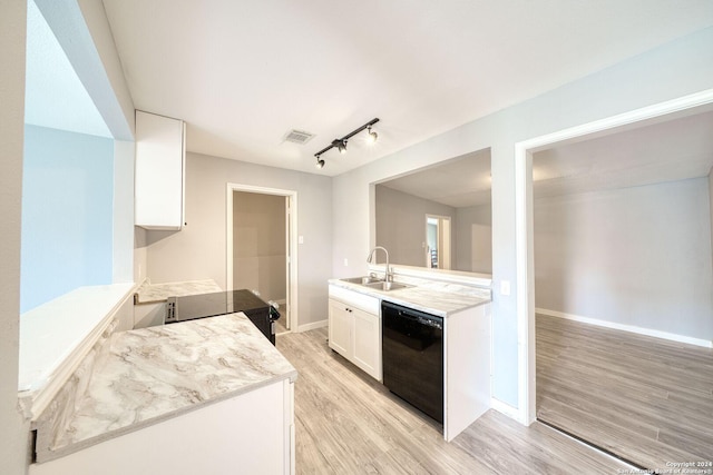 kitchen featuring white cabinets, sink, light hardwood / wood-style floors, and black appliances