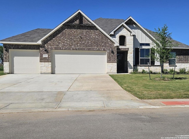 view of front of property with a front yard and a garage