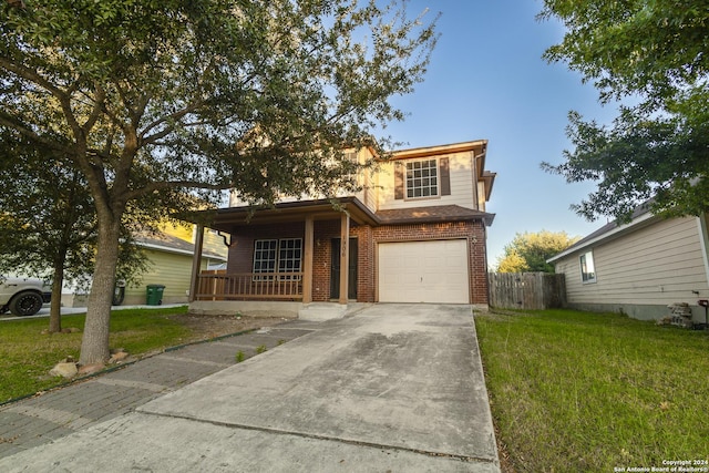 view of front facade with a front lawn, a porch, and a garage