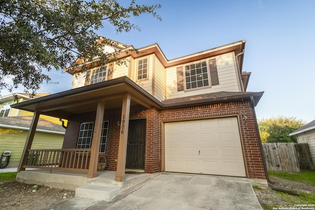 view of front of house with covered porch and a garage