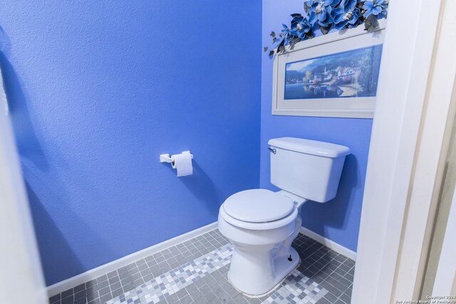 bathroom with tile patterned flooring and toilet