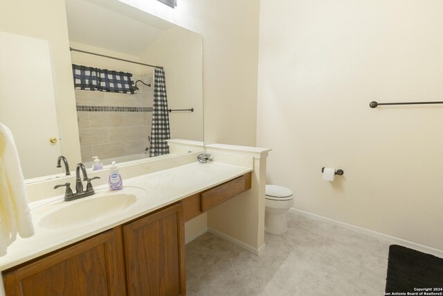 bathroom featuring vanity, curtained shower, and toilet