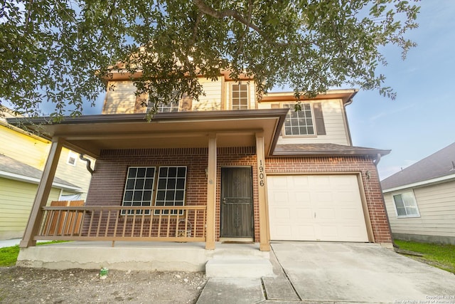 view of front of home with a porch and a garage