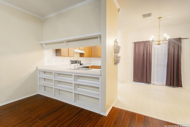 interior space with sink, pendant lighting, dark hardwood / wood-style floors, and ornamental molding