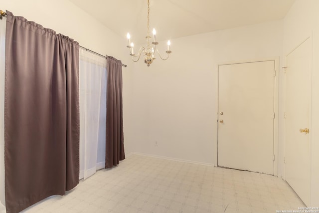 unfurnished room with a chandelier