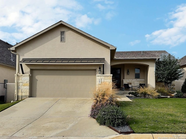 view of front of property featuring a front lawn and a garage