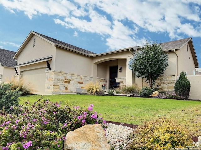 ranch-style house with a front yard and a garage