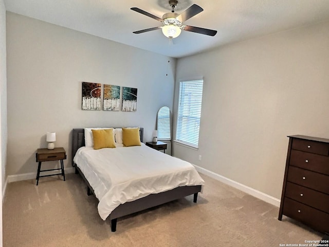 bedroom with light carpet and ceiling fan