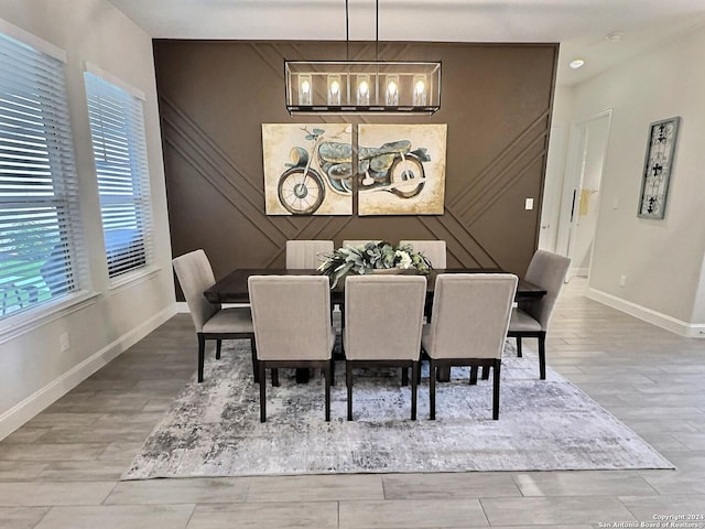 dining room featuring wood-type flooring and a healthy amount of sunlight