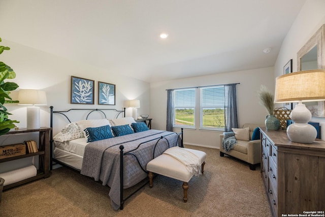 bedroom featuring lofted ceiling and light carpet