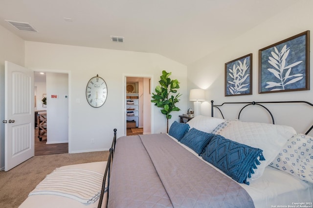 bedroom featuring light colored carpet and vaulted ceiling