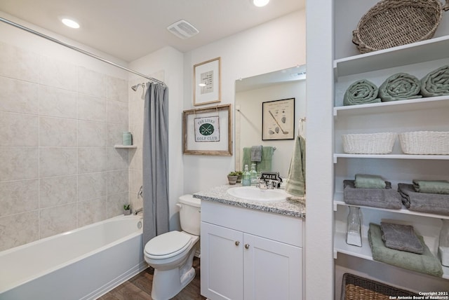 full bathroom with wood-type flooring, vanity, toilet, and shower / tub combo with curtain