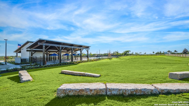 view of property's community with a yard