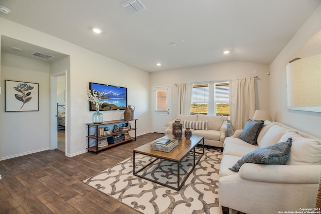 living room featuring dark hardwood / wood-style floors and vaulted ceiling