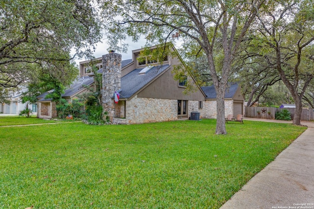 view of home's exterior with a lawn and central AC