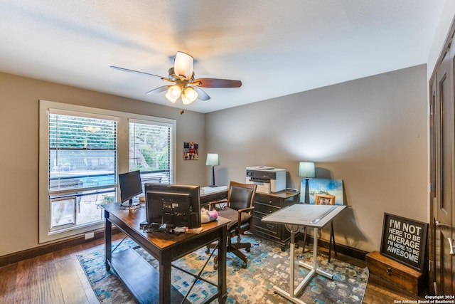 office area with ceiling fan and dark hardwood / wood-style flooring