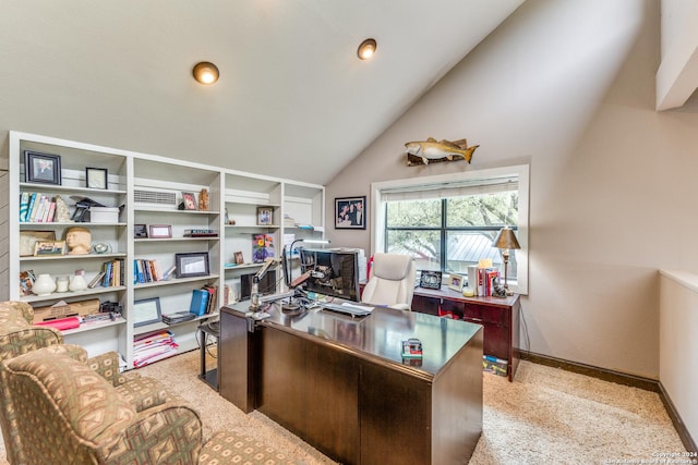 carpeted office with lofted ceiling