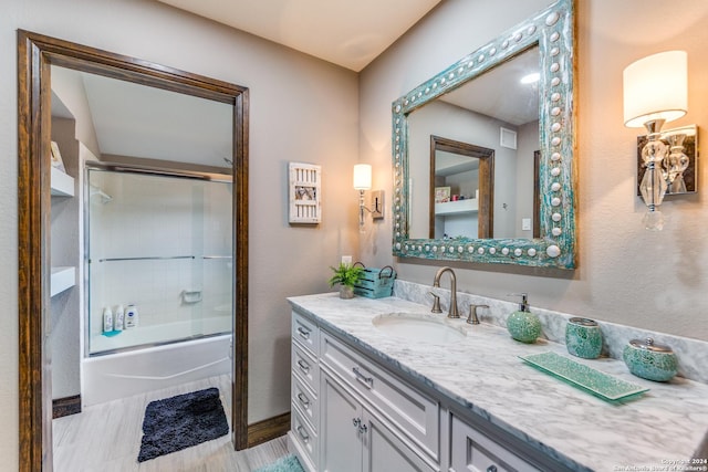 bathroom with shower / bath combination with glass door and vanity