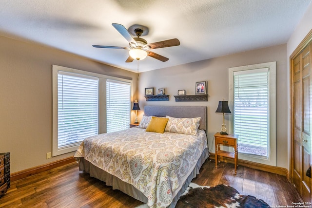 bedroom featuring a textured ceiling, ceiling fan, a closet, and dark hardwood / wood-style floors