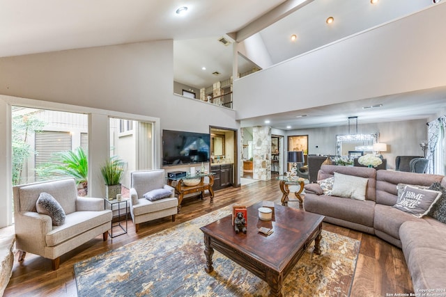 living room featuring beamed ceiling, wood-type flooring, and high vaulted ceiling