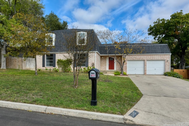 view of front of property with a front yard and a garage