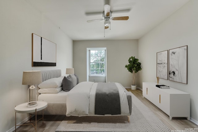 bedroom with light wood-type flooring and ceiling fan