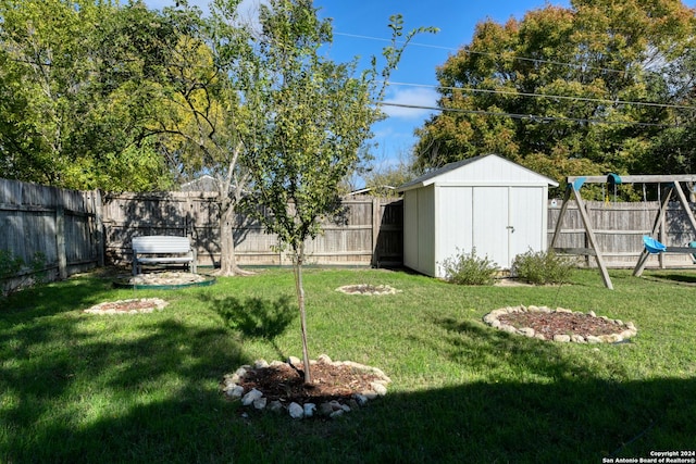 view of yard with a storage unit and a playground