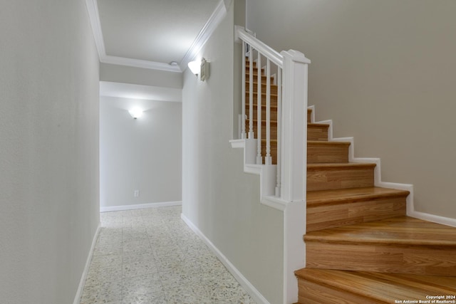 stairs featuring crown molding