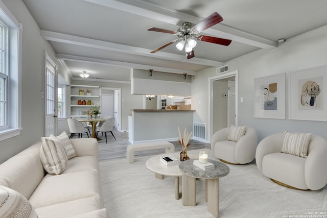 living room featuring ceiling fan and a wealth of natural light