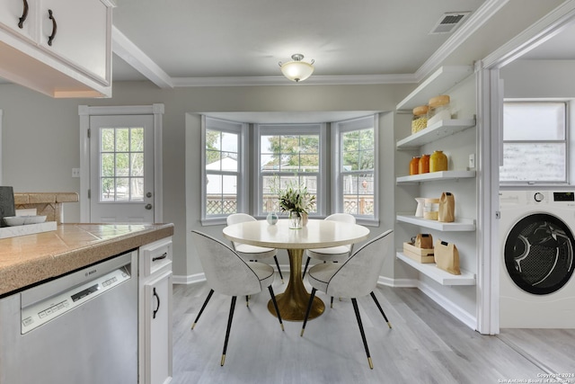 dining area with washer / clothes dryer, crown molding, and light hardwood / wood-style floors