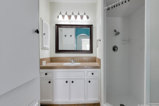 bathroom featuring vanity and a tile shower